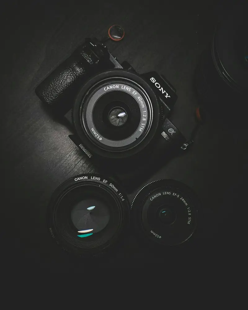 Camera and lenses on a dark table