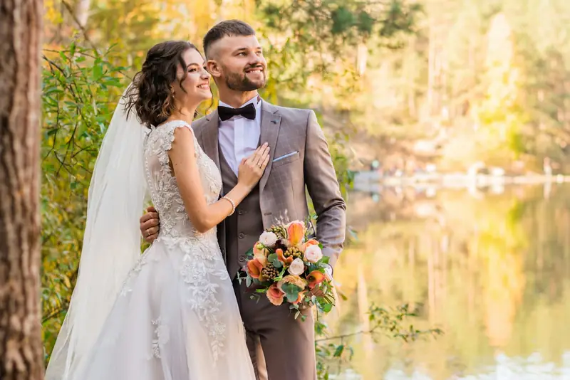 Couple by a lake in autumn colour