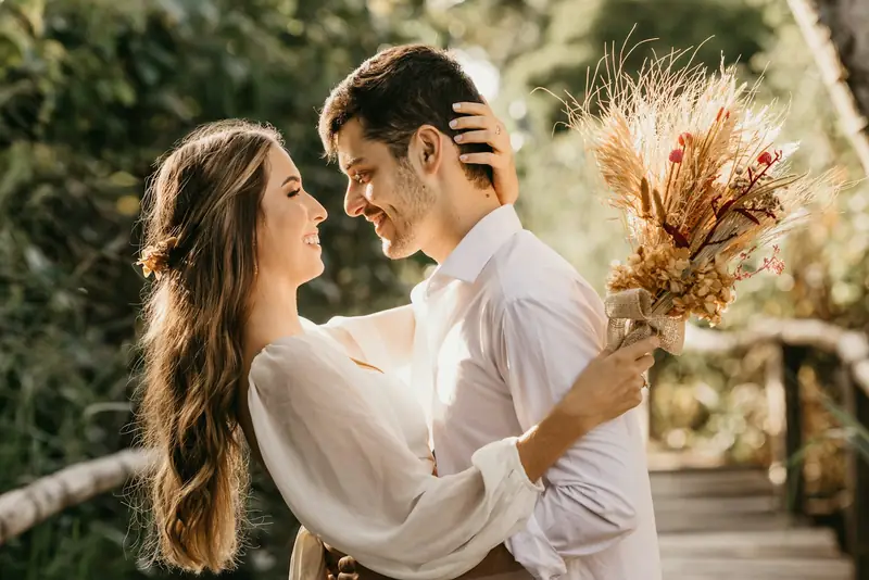 Couple laughing with a dried flower bouquet — our final edit