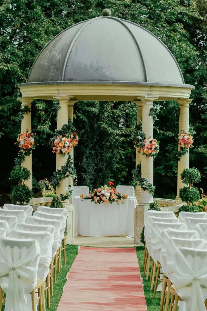 Garden ceremony gazebo with white chairs