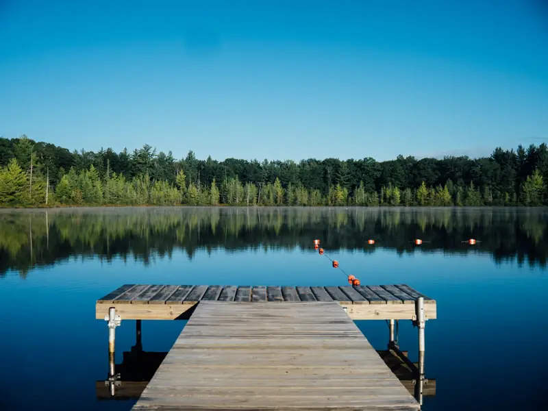 Wooden dock on a calm lake at dawn
