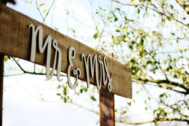 Wooden Mr and Mrs sign in the trees