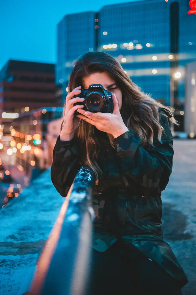 Photographer holding a camera at dusk